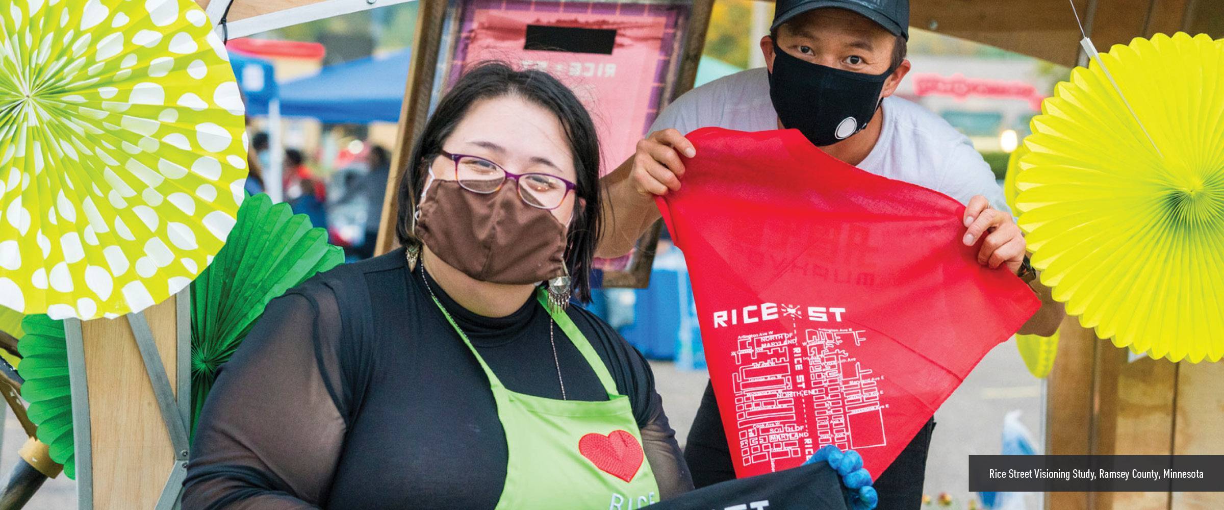 Man and woman holding a t-shirt