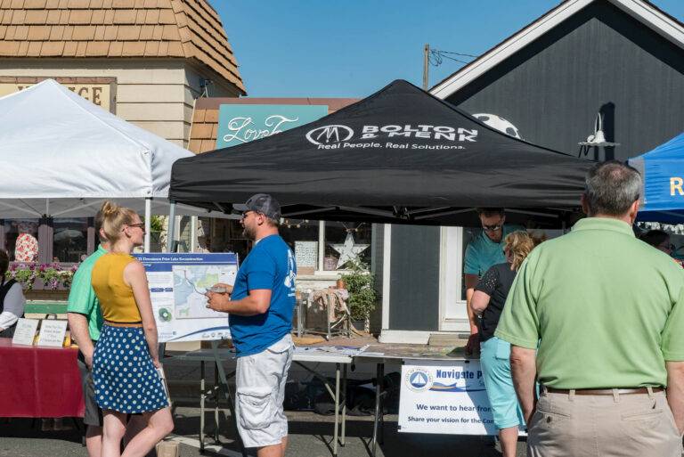 community gathers at farmers market under tent