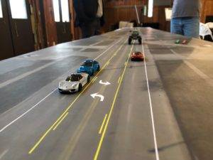 toy cars on a map of the street to demonstrate 3 lane conversion