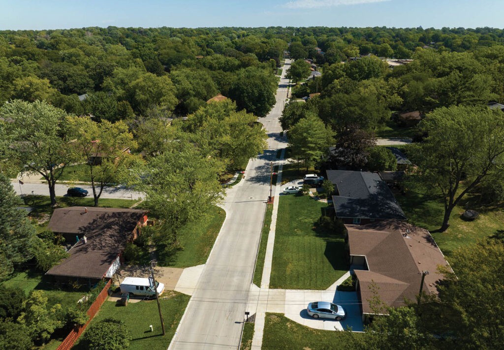 aerial image of a street with trees surrounding it
