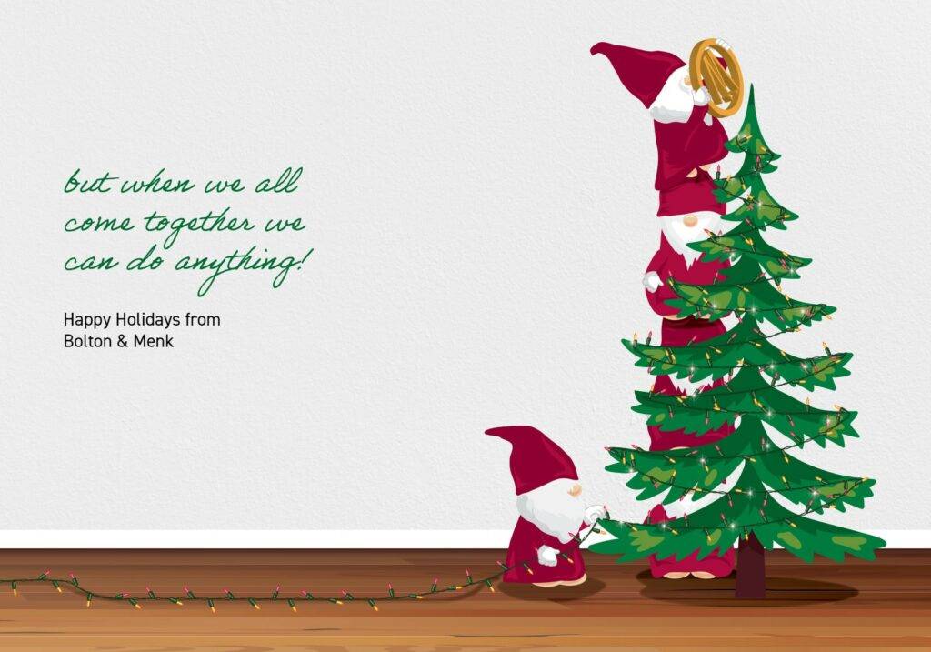 Three gnomes in red hats decorate a Christmas tree. One is on top holding a star, with two stacked beneath to reach. Another gnome untangles lights at the base. Text reads, When we all come together, we can do anything! Holiday greetings from Bolton & Menk!.