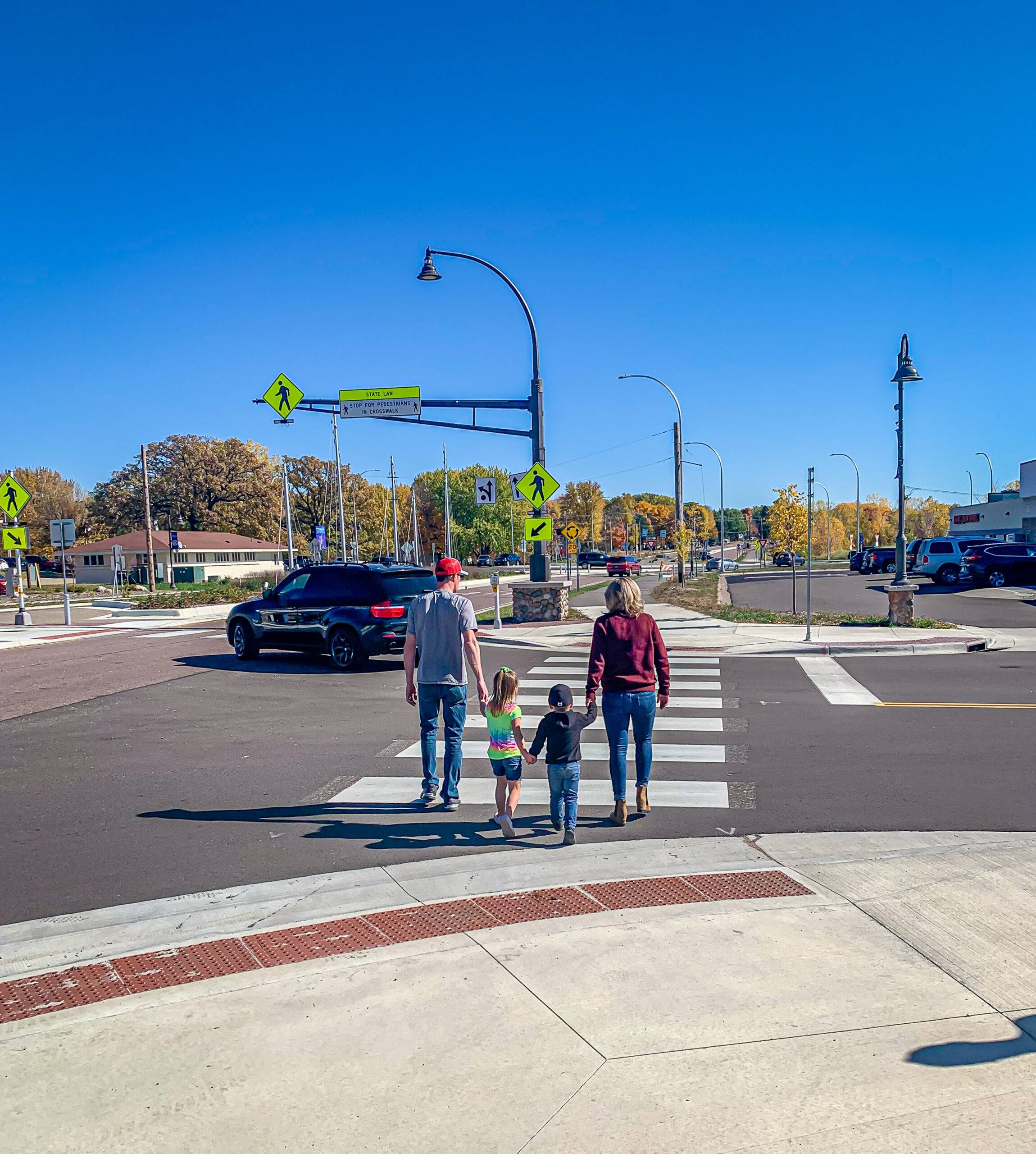 Family walking in crosswalk