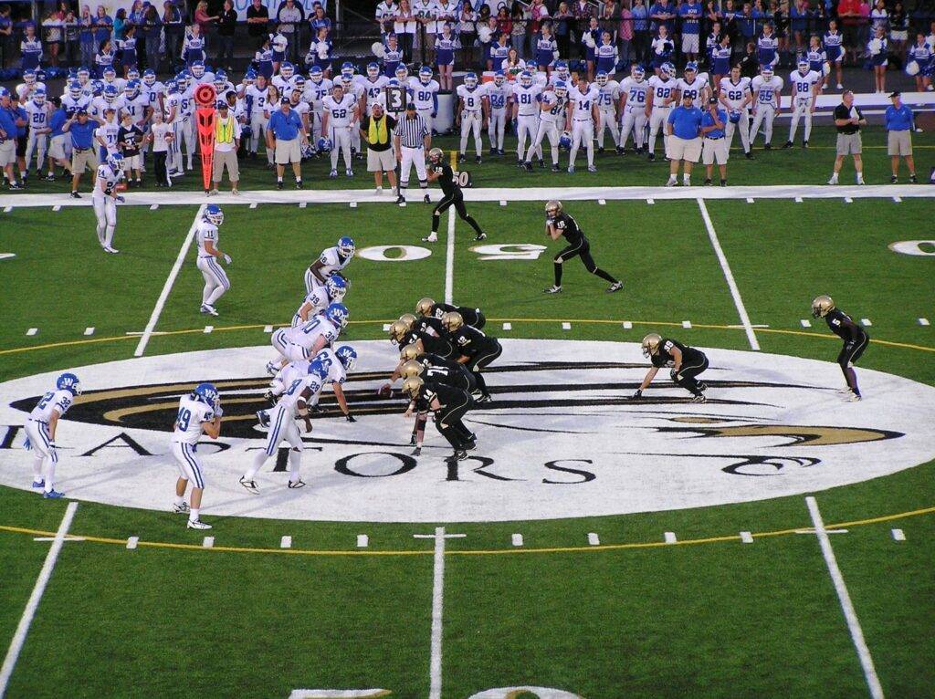 Football players on East Ridge High School synthetic turf field