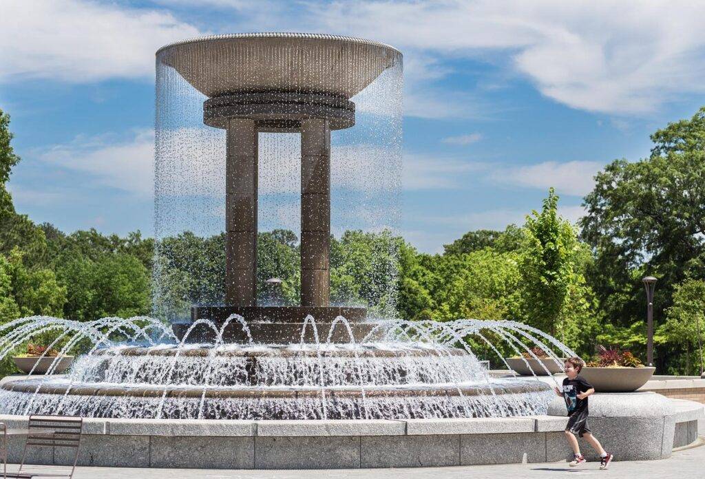 Boy playing at the Town of Cary Downtown Park Fountain promotes public health