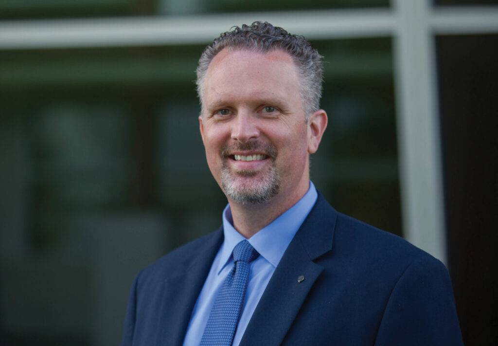 A man smiling in a suit