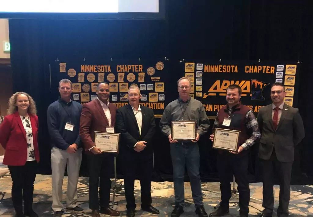 Group of people holding 4th Street Minneapolis Project award and smiling