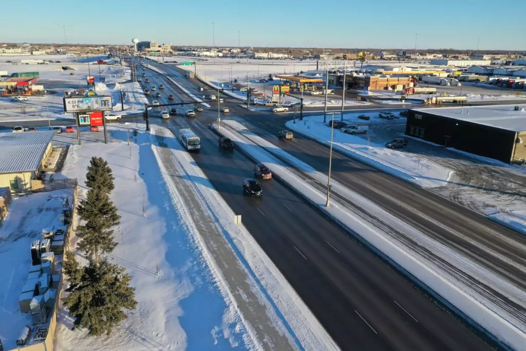 Clean roadway in winter, wet from melting snow.