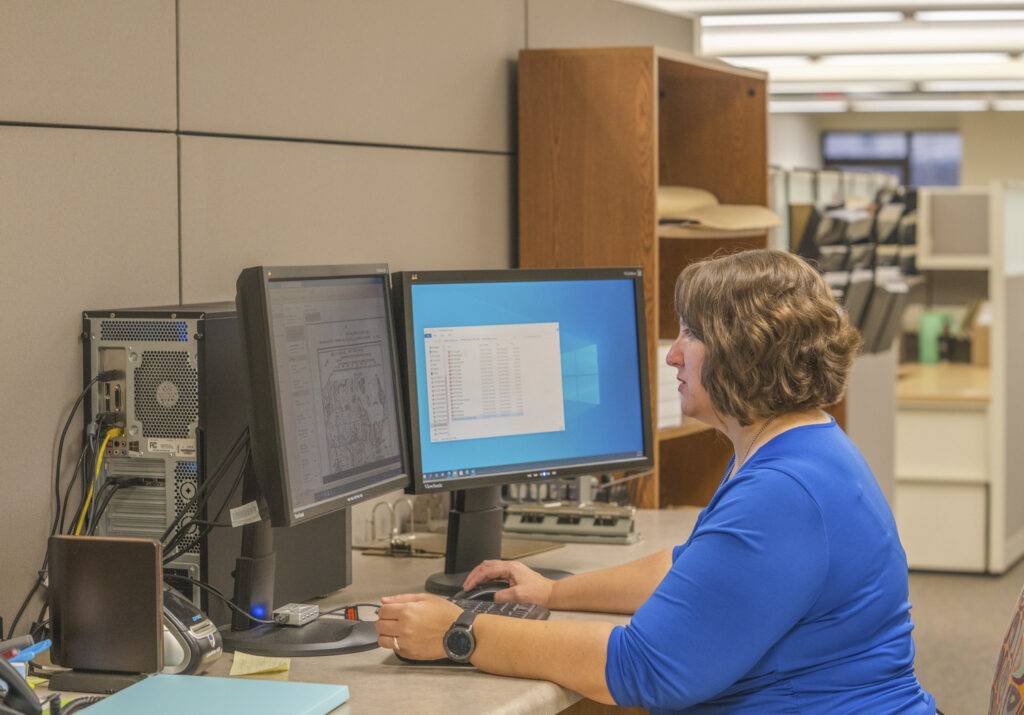 Person at computer desk in an office.