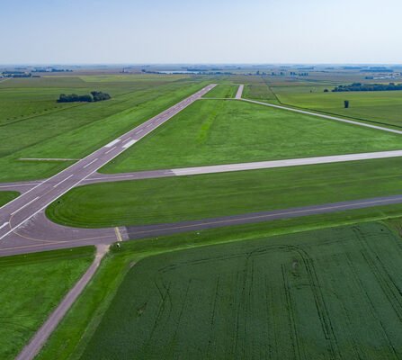 A rural runway with taxi lanes nestled amidst vast fields