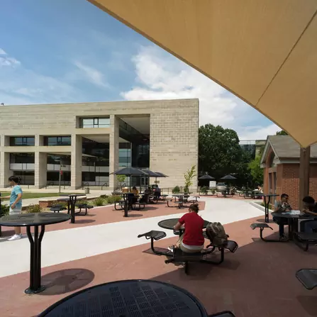 Urban landscape featuring various public seating options with buildings in the backdrop