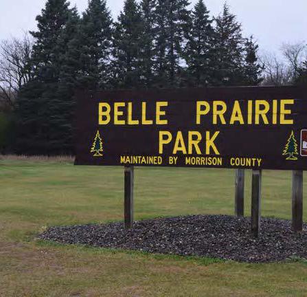 Park sign with trees and grass in the background