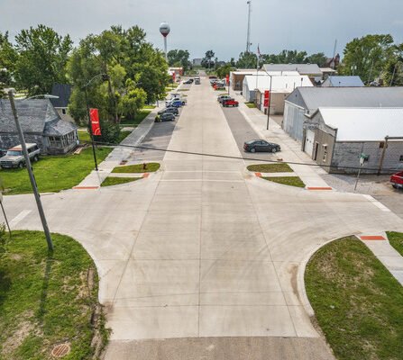 Bird's eye view of downtown intersection with sidewalks and water tower in the background