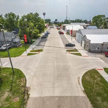 Bird's eye view of downtown intersection with sidewalks and water tower in the background