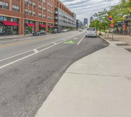 A row of buildings lining a street with sidewalks.