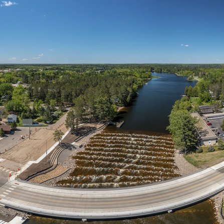 Aerial view of river dam with rock barriers, ensuring water flow control and preventing flooding
