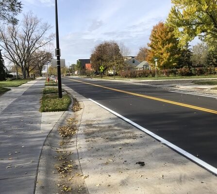 A quiet residential street with sidewalks on both sides