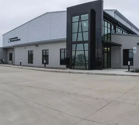 A modern airport exterior featuring large windows and contemporary architecture