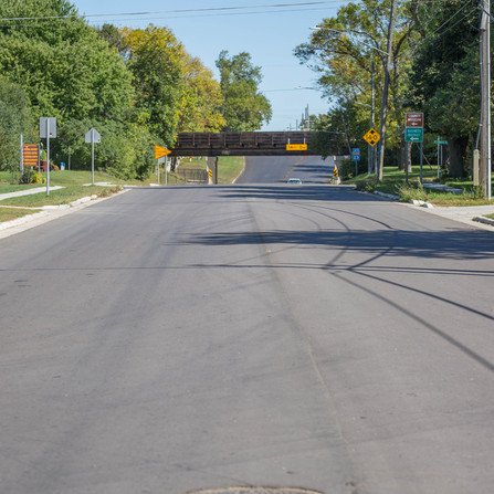 Newly paved road with a bridge in the distance