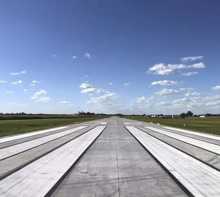 A paved runway marked with white lines