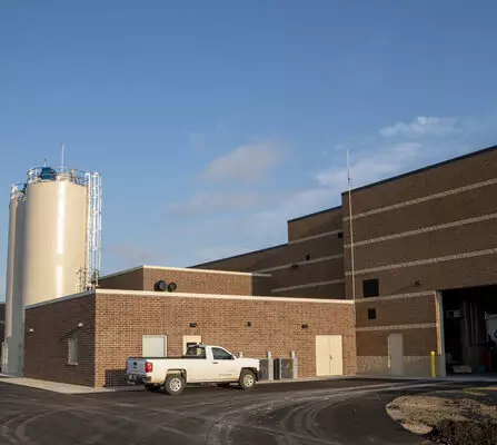 Large brick building with truck parked outside