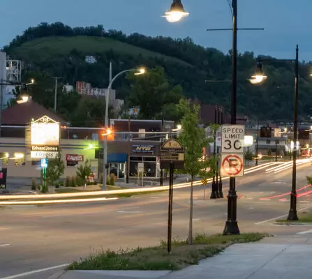 A time-lapse showcases a lively street corridor after dark, with a series of restaurants and office buildings