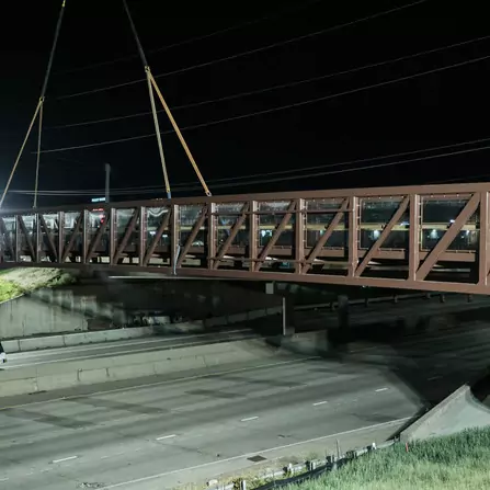 Large bridge is firmly held in place by a crane