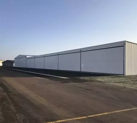 Large aircraft hangar with buildings in the background