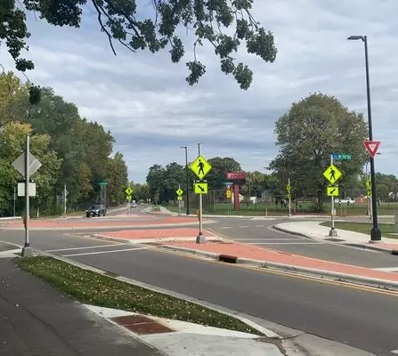 Cars navigating a roundabout with multiple lanes and exits