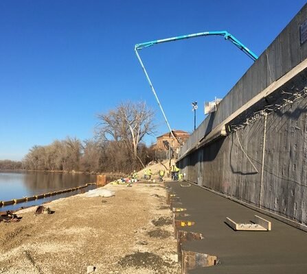 Construction crew working on flood wall construction near the river