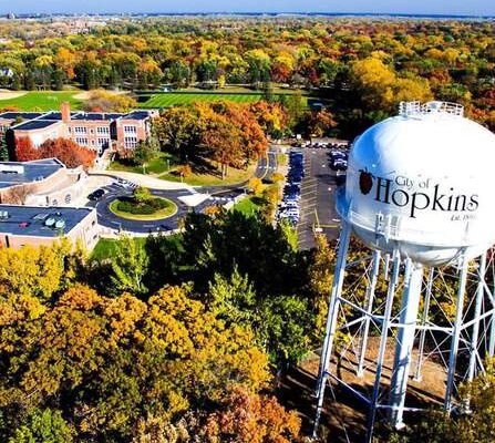 Aerial view of water tower surrounded by buildings and trees