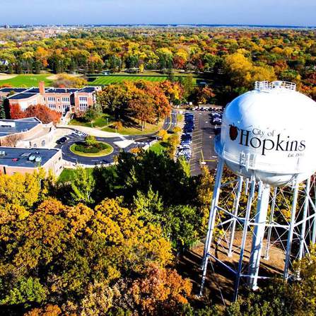Aerial view of water tower surrounded by buildings and trees