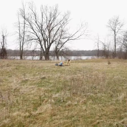A surveyor examining the land, taking notes and measurements