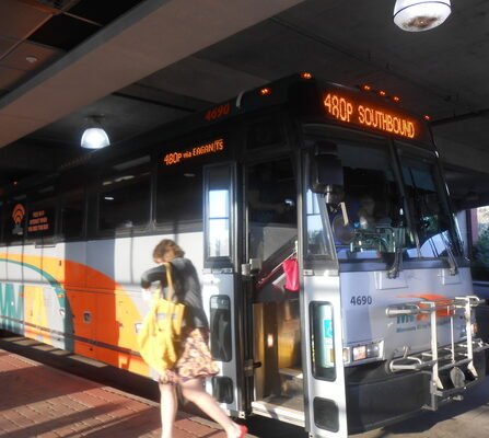 A transit bus dropping off a commuter