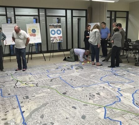 Posters on easels and carpet with a map and people collaboration on pedestrian  plans