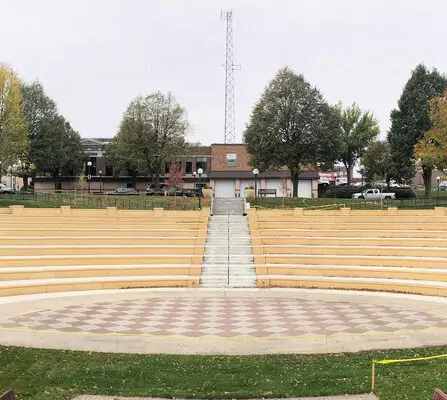 An amphitheater with brick seating and a large central entertainment center