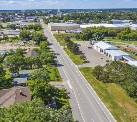 Aerial view of road with buildings and water tower in foreground