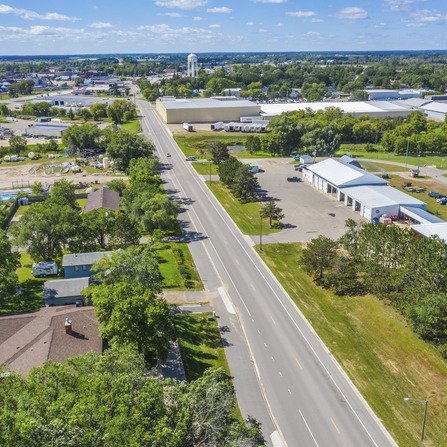 Aerial view of road with buildings and water tower in foreground