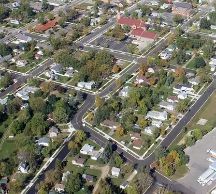 Aerial view of a residential area with houses, roads, and greenery