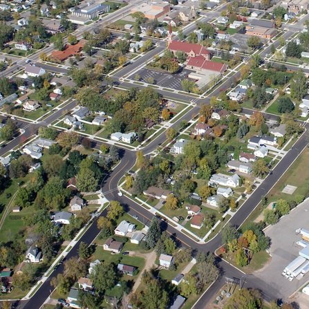 Aerial view of a residential area with houses, roads, and greenery