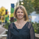 Woman outside smiling at camera