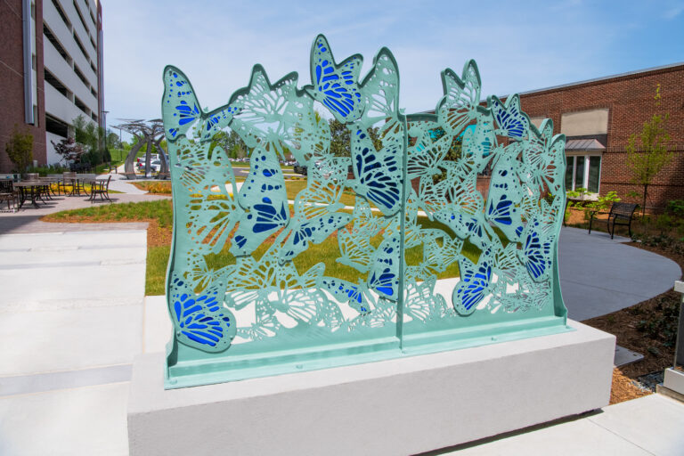 Atrium Health Pineville healing garden light and dark blue butterfly sculpture daytime