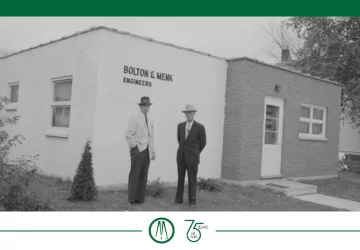 John Bolton and Martin Menk by the entrance of an early office