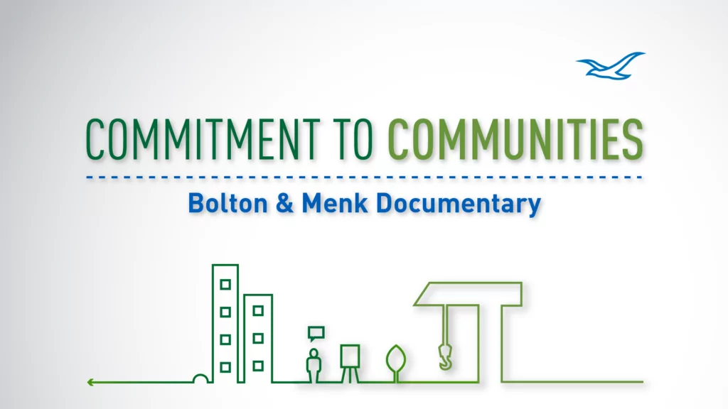 “Commitment to Communities: Bolton & Menk Documentary” text on a white background with simple green line drawings of buildings and infrastructure. Featuring a blue bird in the top right corner, this documentary highlights dedication to community development.