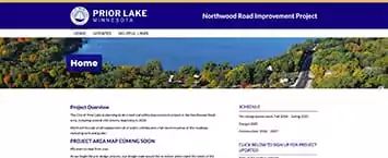 Screenshot of the Prior Lake, Minnesota website displaying the Northwood Road Improvement Project. This public project features a header with Home, an overview, schedule details, and mentions a project area map coming soon. The background showcases a scenic lake view.