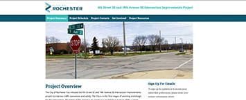 Screenshot of a webpage for a public project in Rochester featuring road improvements. It displays a street intersection with traffic signs and a brief project overview. The page also includes navigation tabs and a section to sign up for email updates.