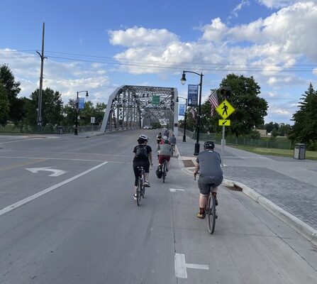 A group of people riding bicycles on a road