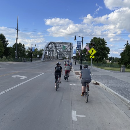 A group of people riding bicycles on a road