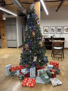 A Christmas tree with presents around it