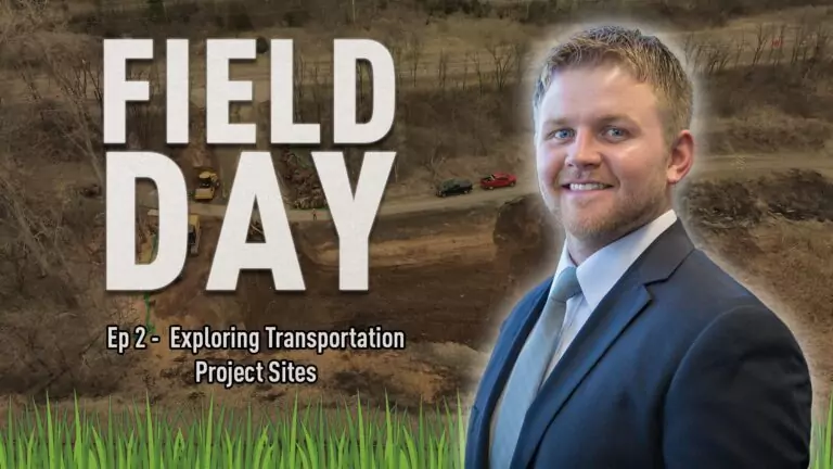 A person in a suit and tie in front of an image of a construction site.