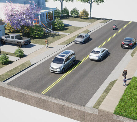 A road with cars and houses